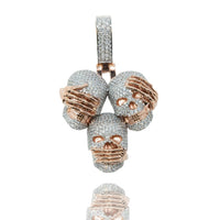 The 14k Hear No Evil, See No Evil, Speak No Evil Pendant features three skulls with rose gold accents, each covering their eyes, ears, or mouth to represent the iconic three wise monkeys motif.