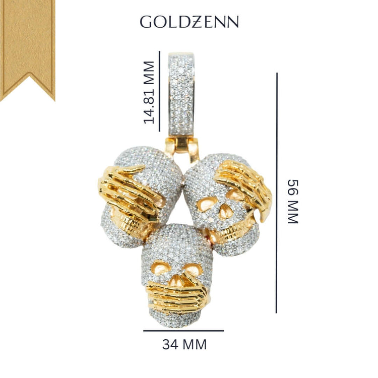 The 14k Hear No Evil, See No Evil, Speak No Evil Pendant features three diamond skulls with gold hands over their eyes, ears, and mouth. Measuring 56mm x 34mm with a 14.81mm bail and “GOLDZENN” above—a striking artistic piece.