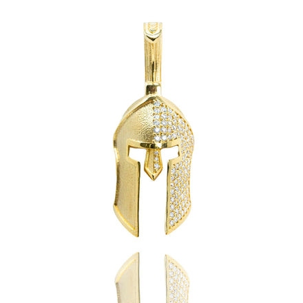 The Half-Face Diamond Spartan Helmet Pendant in 14K Gold, featuring a helmet shape with sparkling white stones on the top and sides, is displayed against a white background.