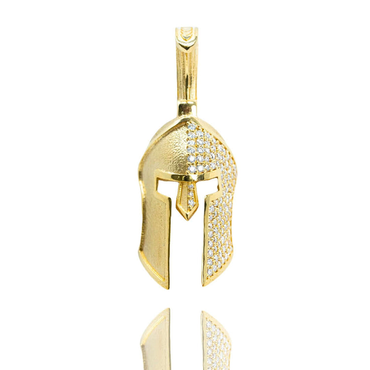The Half-Face Diamond Spartan Helmet Pendant in 14K Gold, featuring a helmet shape with sparkling white stones on the top and sides, is displayed against a white background.