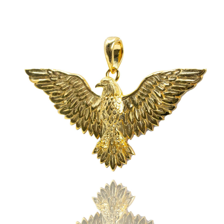 The 14k Yellow Gold Eagle Pendant features outstretched wings and detailed feather engravings, displayed against a white background.