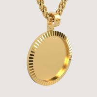 A close-up of the 14K Gold Fluted Round Picture Pendant, featuring a shiny ridged edge and hanging from a thick gold chain against a plain light background.