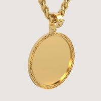 A close-up of the 14K Gold Greek Key Round Picture Pendant on a thick chain, showing its plain center, Greek key border, and lion head detail by the clasp, all set against a plain white background.