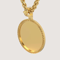 The 14K Gold Greek Key Round Picture Pendant features a blank circular face framed by a Greek key border, hanging from a thick chain. A lion head detail accents the bail. Set against a plain, light background.