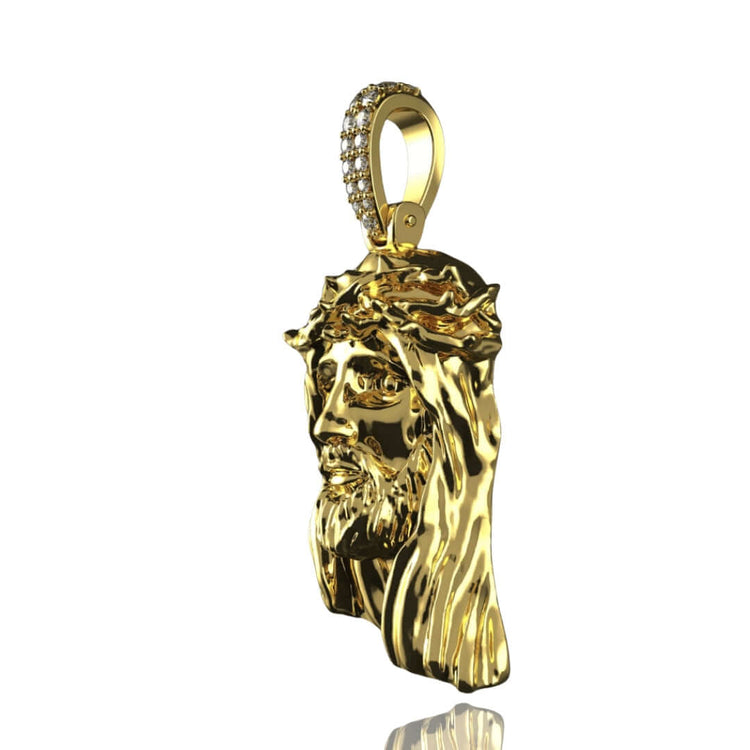The 14K Gold Jesus Face Pendant with Diamond Bail features a detailed Jesus face with a crown of thorns and long hair, perfect for attaching to a chain and shown on a white background.