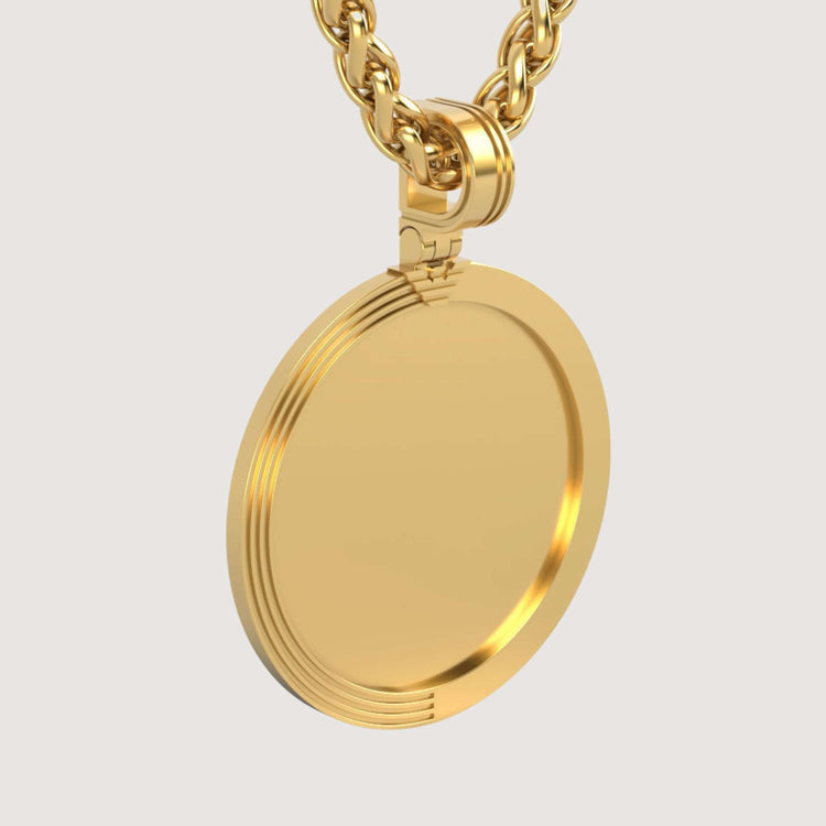 A close-up of the 14K Gold Modern Grooved Round Picture Pendant with a shiny blank surface, suspended from a thick gold chain against a plain light background.