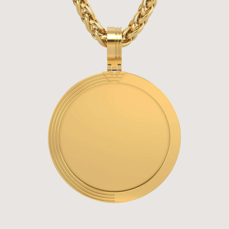 The 14K Gold Modern Grooved Round Picture Pendant, with a polished finish and subtle edge grooves, hangs from a twisted gold chain against a plain background.