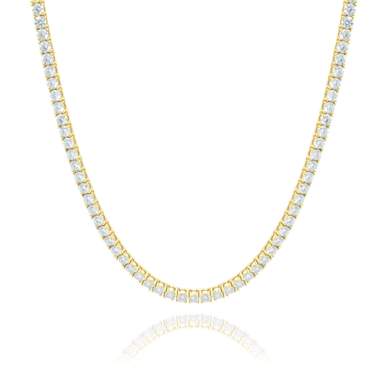 The Tennis Chain - 14K Gold Moissanite showcases a single row of round white stones, set in ethical luxury and elegance. Displayed on a white background with soft reflection, it’s a timeless jewelry piece.