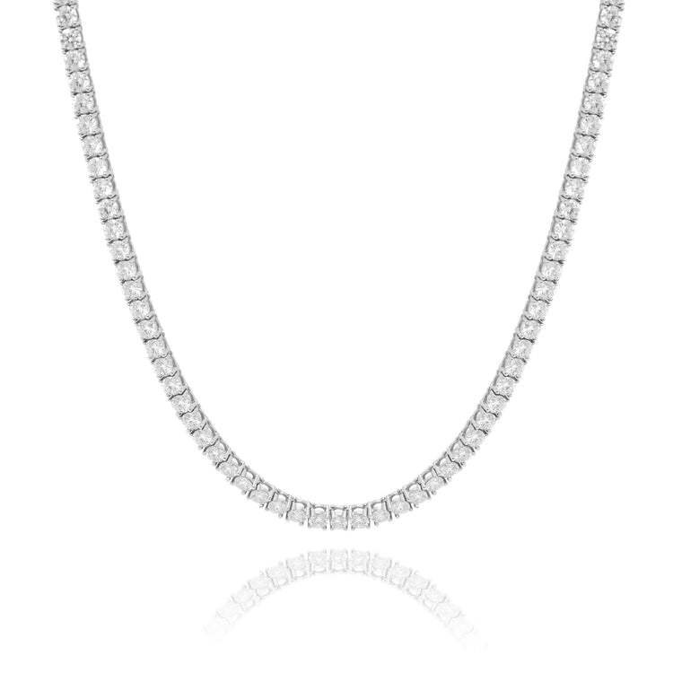 The Tennis Chain - 14K Gold Moissanite features a single row of closely set round moissanite stones in 14K gold, curving gently on a white background with a subtle reflection—an elegant statement of ethical luxury.