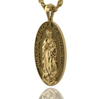 The 14k Gold Nuestra Virgen de Guadalupe Pendant features an embossed Virgin image with "NUESTRA SEÑORA DE GUADALUPE" inscribed around the edge.