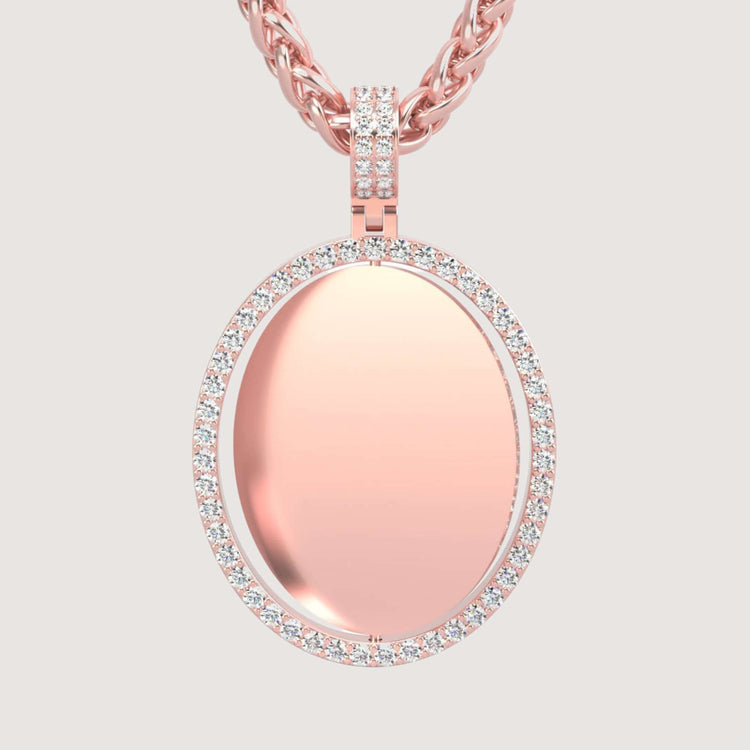 The 14K Gold Open Oval Diamond Picture Pendant features a smooth, polished surface accented with sparkling diamonds and hangs from a twisted rose gold chain against a light background.