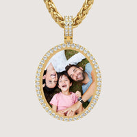The 14k Gold Oval Picture Pendant with Diamonds showcases a joyful family—two adults and a child—smiling and laughing together on the grass in a sparkling diamond-accented gold necklace.