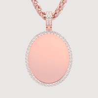 The 14k Gold Oval Picture Pendant with Diamonds features a polished center bordered by sparkling diamonds and hangs from a twisted chain, displayed against a light background.