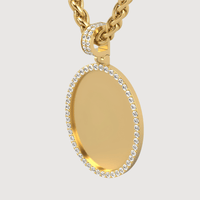 The 14k Gold Oval Picture Pendant with Diamonds features a smooth, blank surface framed by sparkling diamonds and hangs from a thick gold chain—an elegant choice for showcasing a cherished photo.