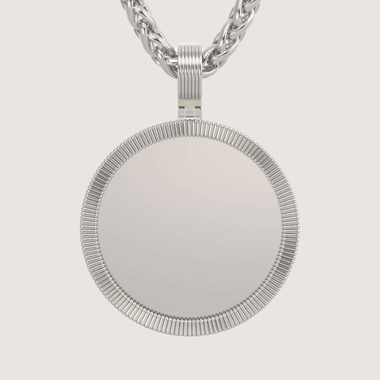 The 14K Gold Ribbed Round Picture Pendant features a ribbed border, smooth reflective center, and thick twisted chain, all set against a plain light background for a timelessly elegant look in personalized gold jewelry.