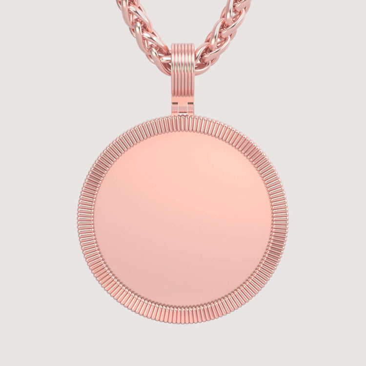 The 14K Gold Ribbed Round Picture Pendant in rose gold hangs from a twisted chain, featuring an unadorned polished center—ideal for those who love minimalist or personalized gold jewelry.