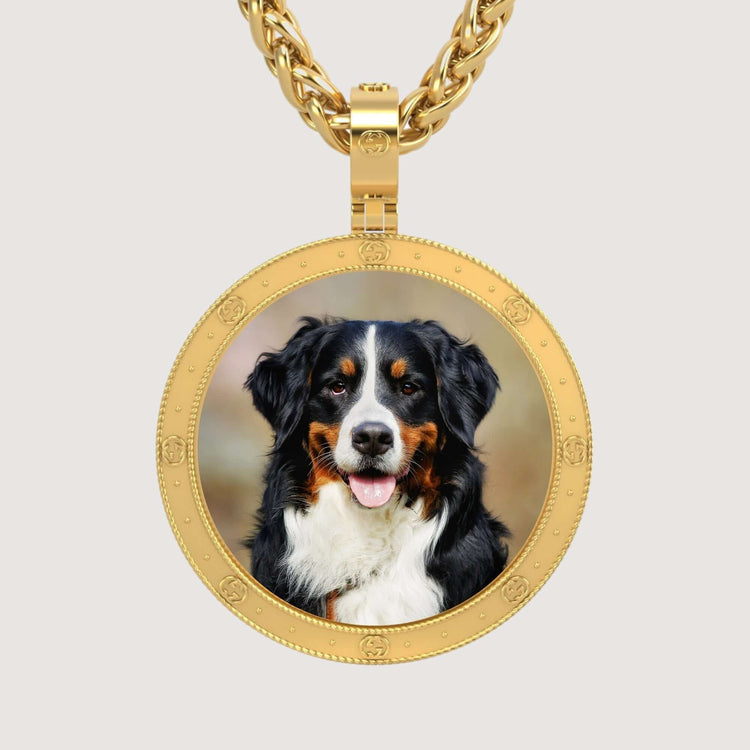 The 14K Gold Round Engraved Border Picture Pendant features a circular frame displaying a Bernese Mountain Dog, shown looking forward with its tongue out and a black, white, and brown coat.