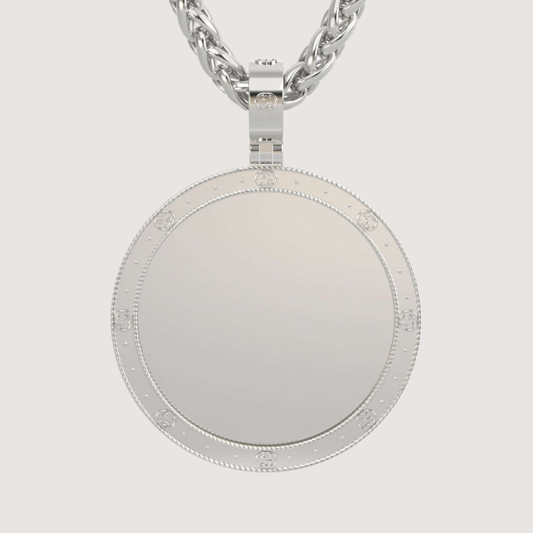 A close-up of the 14K Gold Round Engraved Border Picture Pendant, featuring a smooth reflective surface and textured border, hanging from a thick twisted chain against a plain light background.