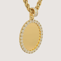 The 14K Gold Scalloped Oval Diamond Photo Pendant features a blank oval medallion rimmed with sparkling diamonds, suspended from a thick gold chain and shown on a plain white background.