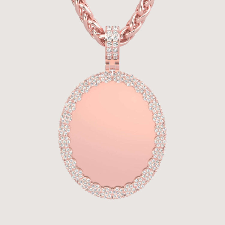 The 14K Gold Scalloped Oval Diamond Photo Pendant features a smooth oval center framed by a border of sparkling diamonds and hangs from a twisted rose gold chain, displayed against a light background.