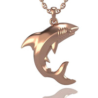The 14k Gold Shark Pendant features a detailed shark with an open mouth and polished fins, hanging from a matching chain. Its shiny finish adds bold style, making this striking pendant perfect for shark jewelry lovers.