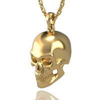 The 14k Gold Skull Pendant hangs from a gleaming gold chain, displayed on a white background. Its detailed teeth, eye sockets, and contours make it an ideal choice for fans of unique skull jewelry.