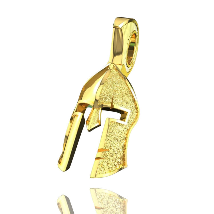 The 14k Gold Heroic Spartan Helmet Pendant features a classic ancient Greek helmet design with smooth and textured surfaces, displayed against a white background with a subtle reflection—a bold piece of Spartan jewelry.
