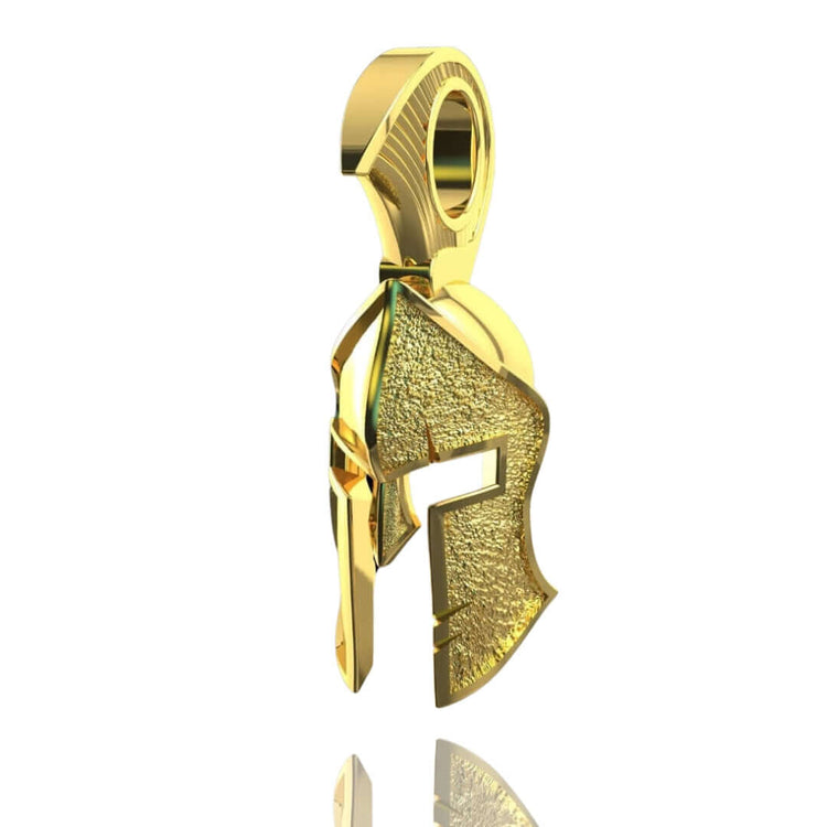 The 14k Gold Heroic Spartan Helmet Pendant features a textured surface and smooth edges, expertly crafted to resemble an ancient warrior helmet—a bold and striking piece of Spartan jewelry shown on a white background.