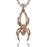 The 14k Gold Spider Pendant showcases a stylized spider with detailed legs and body, elegantly hanging from a chain—an eye-catching piece of spider jewelry.