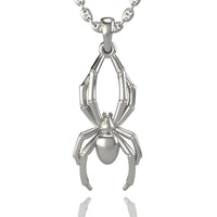 The 14k Gold Spider Pendant features a stylized spider design with detailed legs and a polished body, showcasing unique spider jewelry craftsmanship and hanging elegantly from a chain against a white background.
