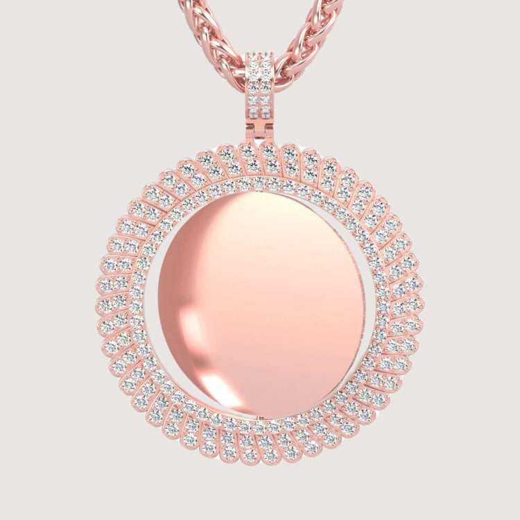 The 14K Gold Sunburst Diamond Round Picture Pendant features a polished round center framed by two rows of white stones, hanging from a braided rose gold chain against a light background.