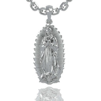A 14k gold Virgen de Guadalupe pendant featuring the Virgin Mary with hands in prayer, set against a textured background with an oval radiant border—a timeless symbol of faith.