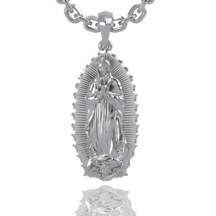 A 14k gold Virgen de Guadalupe pendant featuring the Virgin Mary with hands in prayer, set against a textured background with an oval radiant border—a timeless symbol of faith.