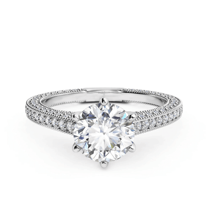 The 14k Round Lab Diamond Engagement Ring features a large round lab diamond in a prong setting with a split shank band adorned with pavé diamonds, offering timeless elegance for an unforgettable proposal.