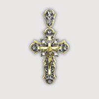 The 14K Yellow Gold Fancy Diamond Jesus Cross Pendant features Jesus on the cross with ornate floral patterns, gold and silver details, INRI at the top, and resembles a decorative religious jewelry piece against a white background.