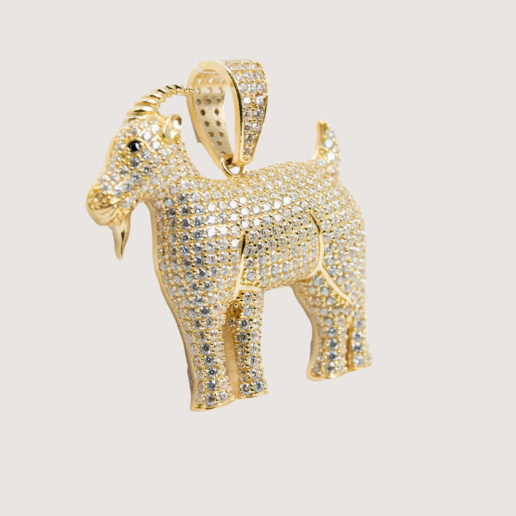 The 14K Yellow Gold Goat Pendant features sparkling CZ stones, detailed facial features, elegant horns, and a loop for attaching to a necklace.