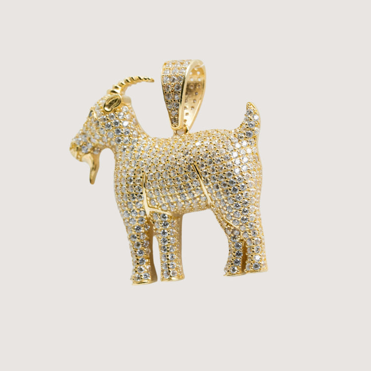 A 14K Yellow Gold Goat Pendant with sparkling CZ stones features a detailed horn, beard, and raised tail, set against a plain light background.