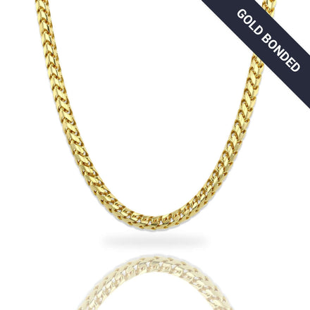 The Franco Chain - 3mm-3.5mm 14k Gold Bonded is showcased on a white background with a black diagonal "GOLD BONDED" banner. Its reflection emphasizes the necklace's brilliant shine and substantial thickness.