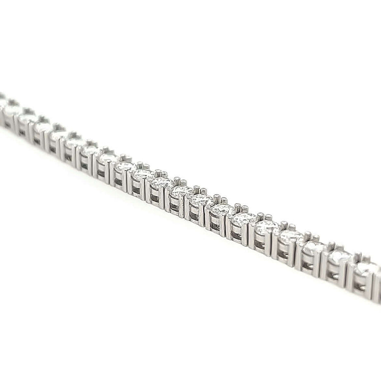 Close-up of a Tennis Chain - 14k Gold Lab Diamond, featuring a row of small, round, sparkling lab-grown diamonds set in a straight line against a white background.