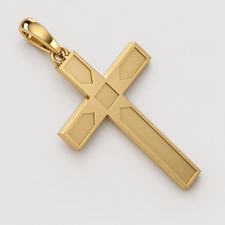 The 14k Gold Beveled Cross Pendant, featuring geometric detailing and beveled edges, is displayed against a plain warm off-white studio background.