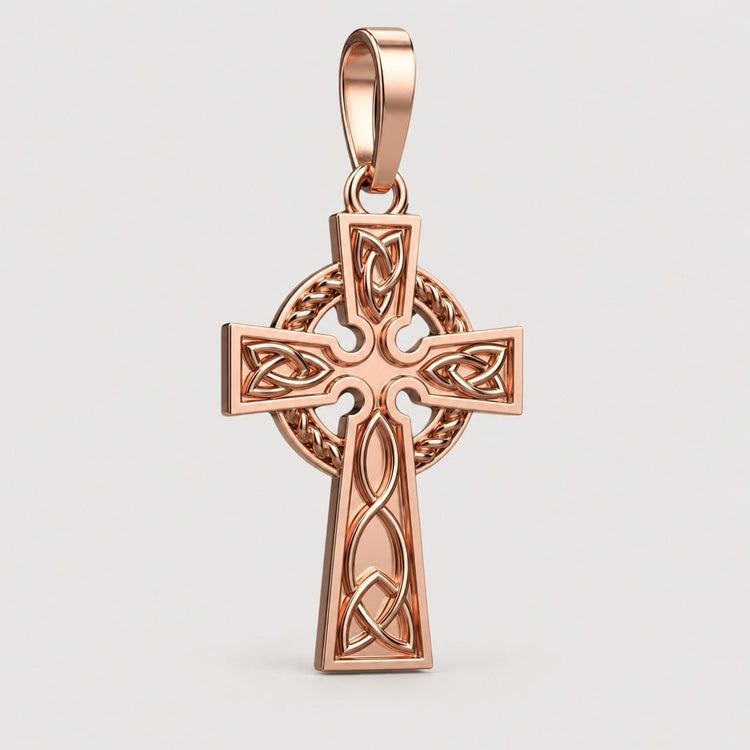 The 14k Gold Celtic Cross Pendant features detailed knotwork and a chain loop, showcased elegantly on a warm off-white studio background.