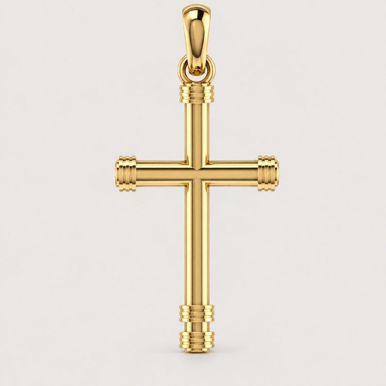 The 14k Gold Cylindrical Cross Pendant features ribbed detailing on the ends and hangs from a matching gold loop, displayed against a plain light background.