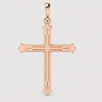 The 14k Gold Decorative Cross Pendant features pointed tips and intricate engravings, showcased against a simple light background.