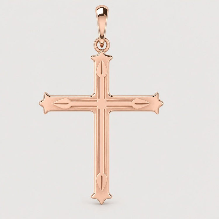 The 14k Gold Decorative Cross Pendant features pointed tips and intricate engravings, showcased against a simple light background.