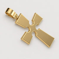 The 14k Gold Gothic Cross Pendant features beveled edges and circular cutouts at each corner, shown against a warm off-white studio background.