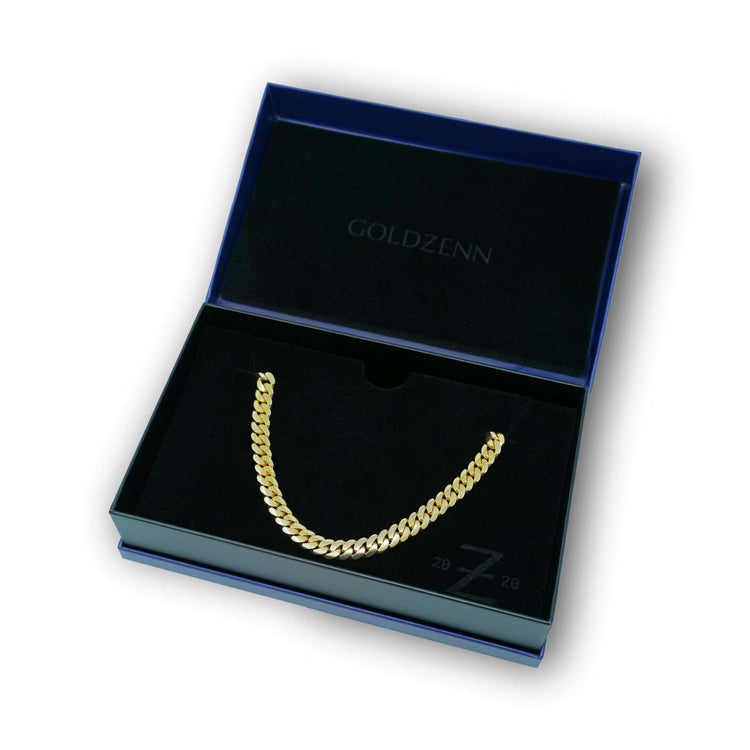 A 15mm Handmade Miami Cuban Link Chain in 10K/14K solid gold displayed in an open, black velvet-lined blue box with the GOLDZENN logo printed inside the lid.