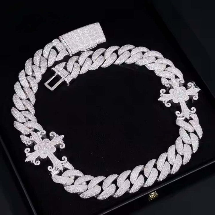 The Moissanite Cross Cuban Link Chain - 18mm is a thick 925 sterling silver necklace with VVS moissanite stones, three ornate cross designs, and a large rectangular clasp, showcased on a black surface.