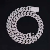 The Moissanite Cuban Link Chain - 18mm is a thick, 925 sterling silver bracelet encrusted with VVS moissanite diamonds, displayed in a circular shape on a plain black background.