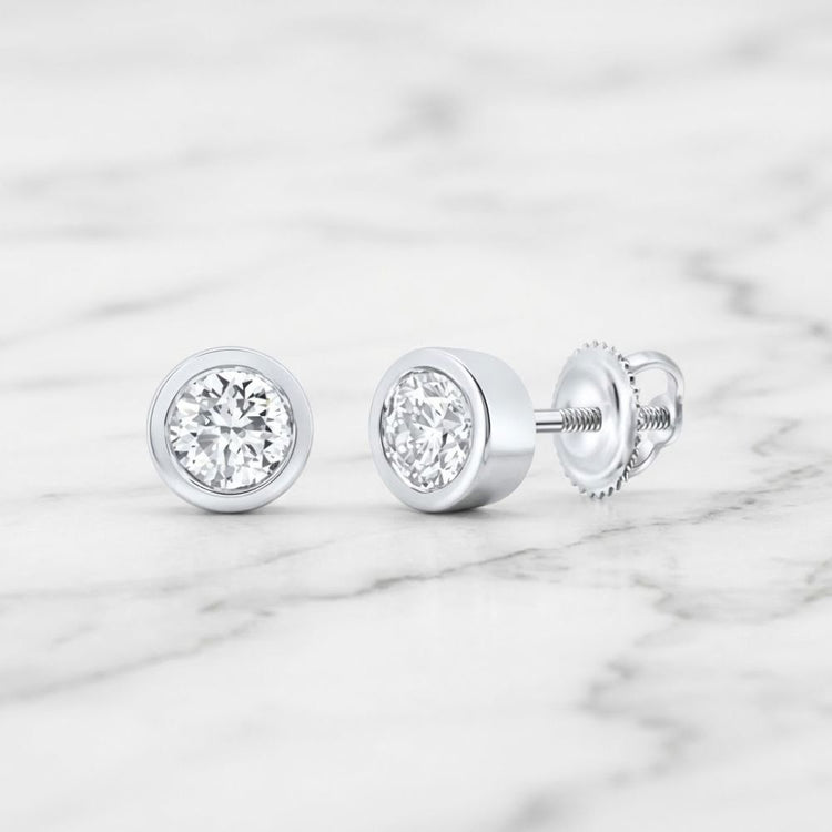 3/4CTW Natural Diamond Solitaire Stud Earrings featuring round-cut natural diamonds in bezel settings with threaded posts and screw-back closures.
