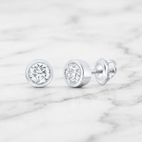 3/4CTW Natural Diamond Solitaire Stud Earrings featuring round-cut natural diamonds in bezel settings with threaded posts and screw-back closures.